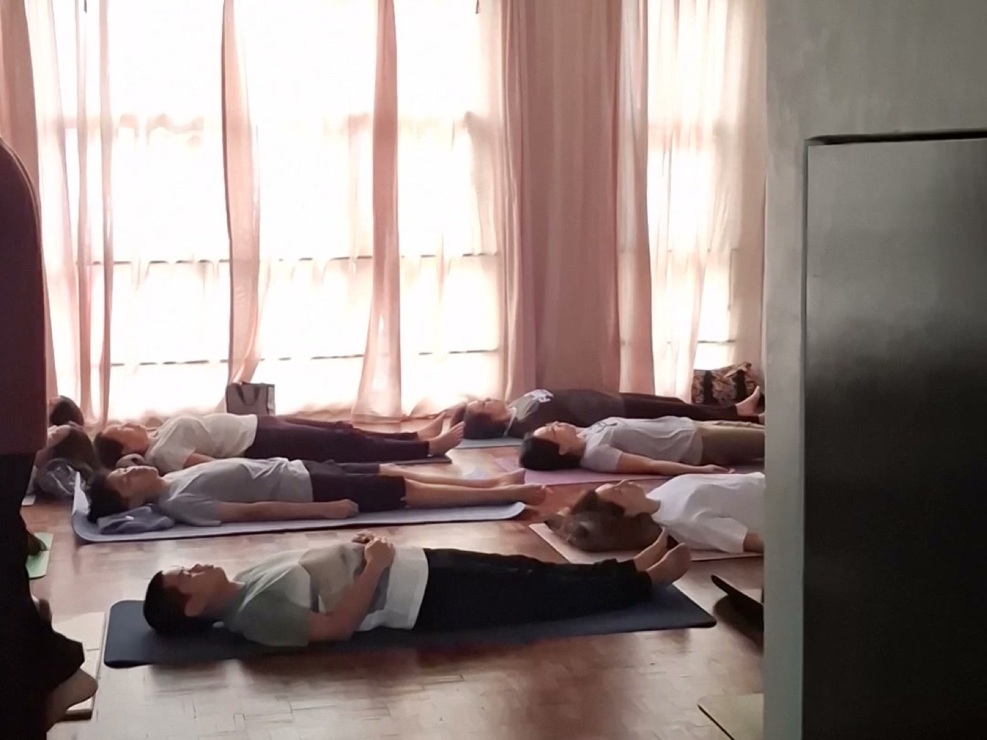 A group lying down to rest during a breathwork session