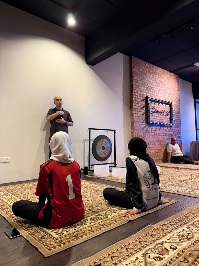Hong guiding participants through a practical breathwork session