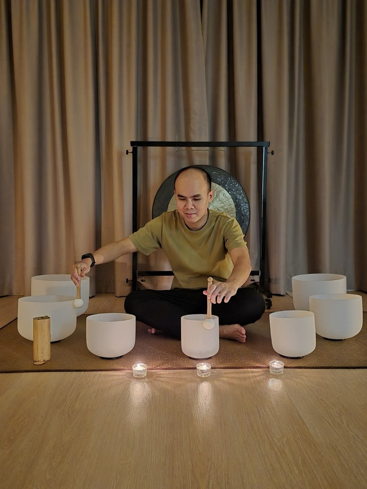 Hong playing crystal singing bowls
